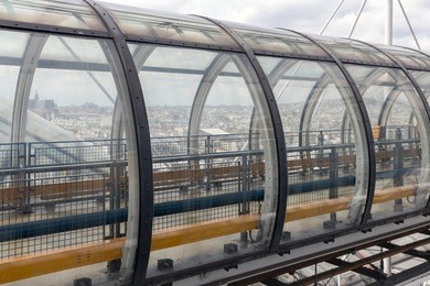 glass tube corridor at pompidou centre with aerial view at the city of paris