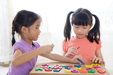 asian kids playing alphabet letters
