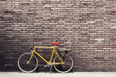 retro bicycle on roadside with vintage brick wall background