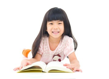 asian girl lying on the floor and reading
