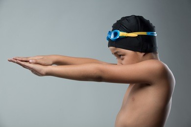 boy prepare to swim freestyle on grey background