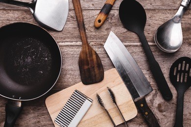 old kitchenware on wooden background.