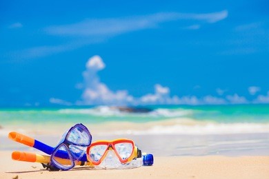 colorful snorkel gear by the sea, remote tropical beaches and countries. travel concept