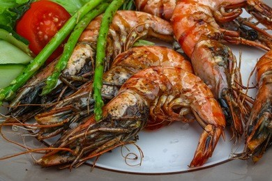 grilled tiger prawn with asparagus and salad leaves