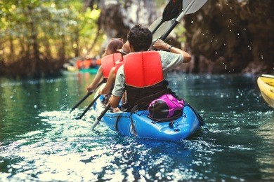 family kayaking and makes selfie 