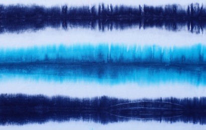 striped tie dyed pattern on cotton fabric abstract background.
