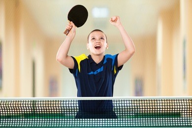 portrait of kid playing tennis celebrating flawless victory in table tennis 