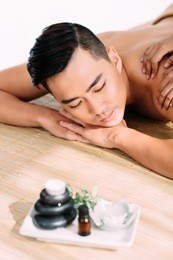 asian young man enjoying professional back massage in the spa center