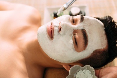 face of handsome man having spa treatment in beauty salon