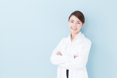 portrait of young asian doctor isolated on blue background