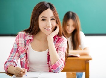 smiling young  student with others  in the classroom