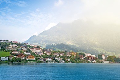 swiss village on lucerne lake on foggy day, switzerland