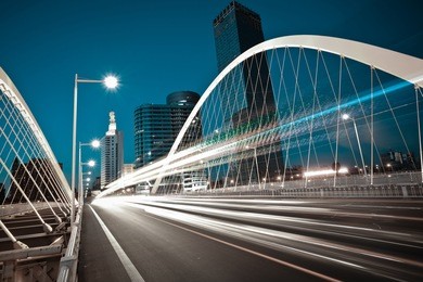 modern city road arc ironbridge night landscape of car light trails in tianjing