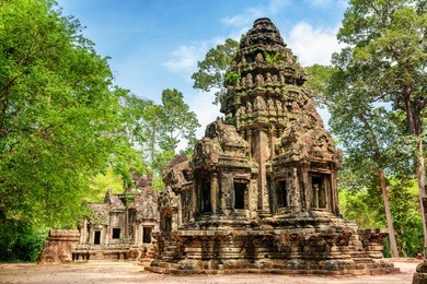 main tower of ancient thommanon temple in amazing angkor, siem reap, cambodia. mysterious thommanon nestled among rainforest. blue sky in background. enigmatic angkor is a popular tourist attraction.
