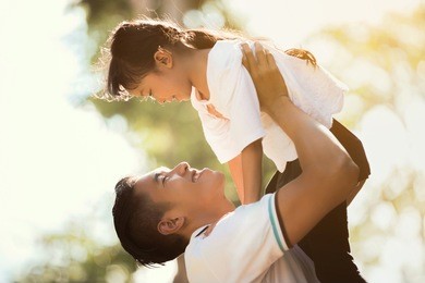 father carrying daughter up looking at each other happily, the early morning hours