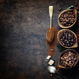top view of three different varieties of coffee beans on dark vintage background