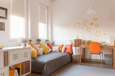 yellow and orange accessories in modern teen room