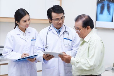 doctor showing results of medical analysis to his senior patient
