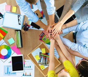 business team with hands together - teamwork concepts