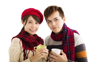 happy young couple drinking hot tea isolated on white background