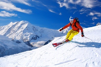 skier skiing downhill in high mountains, matterhorn area, switzerland
