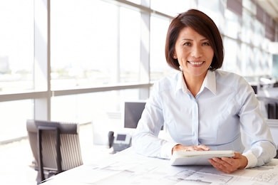 female architect using tablet computer, looking to camera