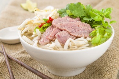 pho bo - vietnamese fresh rice noodle soup with beef, herbs and chili. vietnam's national dish.

