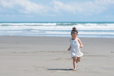 girl playing on the beach