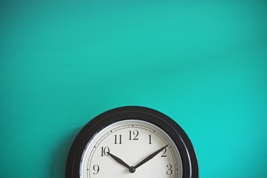 clock on mint green wall background. vintage effect. concept of time.
