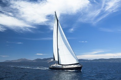 sailing ship yachts with white sails in the sea. luxury boats.