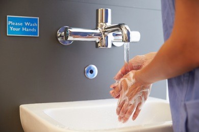 close up of medical staff washing hands