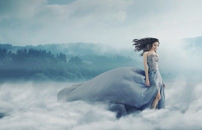 magical brunette lady on a foggy field