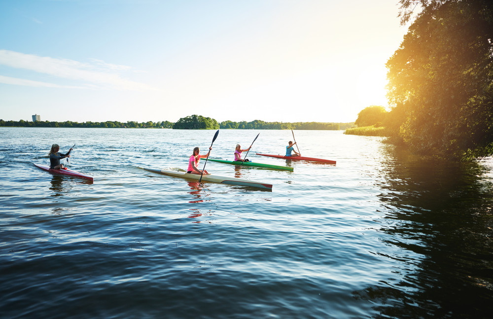 team of sports kayaks racing on the lake