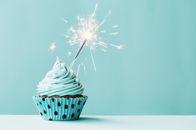 cupcake with sparkler against blue