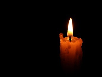one candle flame at night closeup