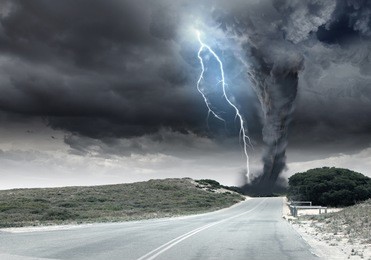black tornado funnel and lightning on road