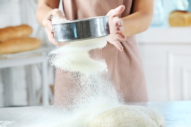 making dough by female hands at bakery