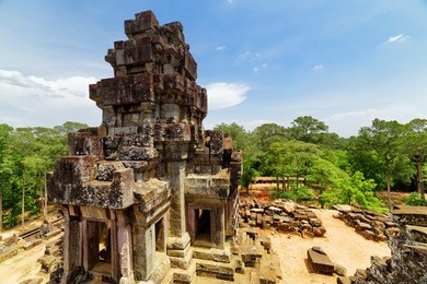 top view of ancient prang of mysterious ta keo temple in amazing angkor, siem reap, cambodia. blue sky and woods in background. angkor is a popular tourist attraction.