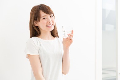 young attractive asian woman who drinks water