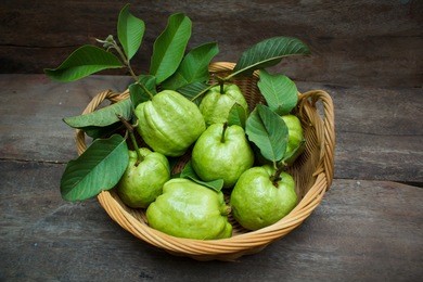 fresh green guavas on old wood background.