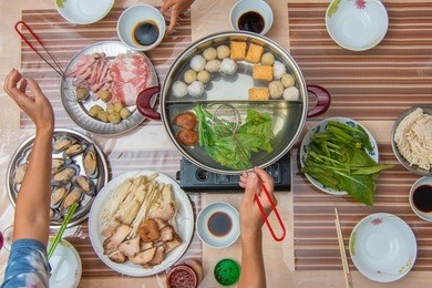 chinese family eating hot pot top view
