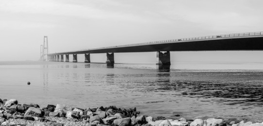 the great belt bridge (the east bridge) in denmark that runs between the danish islands of zealand and funen. black and white photo