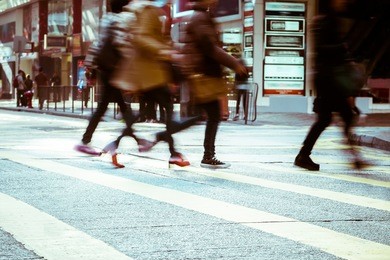 blurred image of people moving in crowded city street. art toning abstract urban background. hong kong