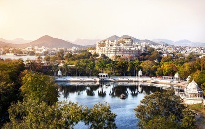 lake pichola with city palace view in udaipur, rajasthan, india