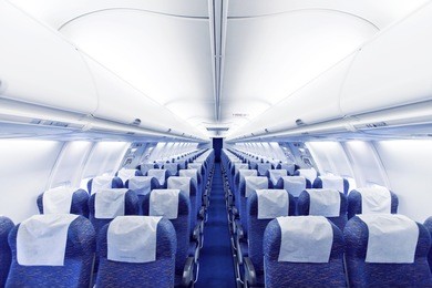 modern airplane seats in perspective. transportation concept. aircraft's corridor interior in modern tones.