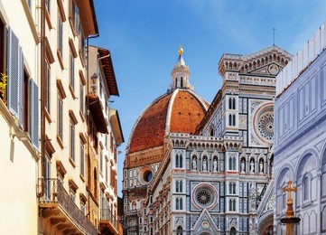 the cathedral of saint mary of the flower (florence cathedral) at historic center of florence, tuscany, italy. view from the piazza san giovanni. dome on blue sky background.