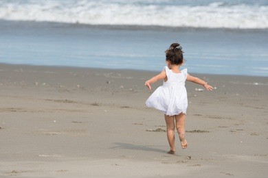 girl playing on the beach