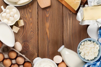 dairy products on wooden table. milk, cheese, egg, curd cheese and butter. top view with copy space