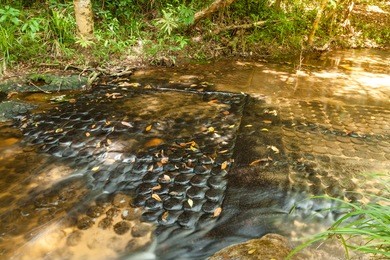 carvings lingam underwater, kbal spean waterfall national park at kulen hills, siem reap, cambodia.