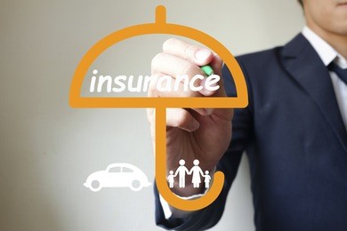 businessman writing insurance umbrella for family and car , business idea insurance concept